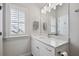 Bright bathroom with marble countertop vanity, decorative lighting, and a large mirror at 530 Bismark Ne Rd, Atlanta, GA 30324