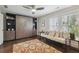 Bedroom featuring built-in wall unit, daybed, modern ceiling fan, and wood flooring at 530 Bismark Ne Rd, Atlanta, GA 30324