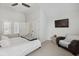 Bedroom features a vaulted ceiling, plantation shutters, a wall-mounted TV, and an armchair at 530 Bismark Ne Rd, Atlanta, GA 30324