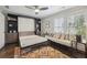 Bedroom featuring built-in wall unit with a pull-down bed, daybed, modern ceiling fan, and wood flooring at 530 Bismark Ne Rd, Atlanta, GA 30324