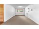 Large basement space with neutral carpet, light walls, and a small window at 9283 Whaleys Lake Ln, Jonesboro, GA 30238