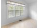 Bedroom featuring a large window with blinds and neutral-colored walls at 9283 Whaleys Lake Ln, Jonesboro, GA 30238
