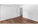 Spacious bedroom features laminate wood flooring, double closets, and neutral paint at 9283 Whaleys Lake Ln, Jonesboro, GA 30238