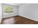 Bedroom featuring a window overlooking the street and hardwood floors at 9283 Whaleys Lake Ln, Jonesboro, GA 30238