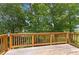 Spacious wooden deck with railings, perfect for enjoying the surrounding greenery at 9283 Whaleys Lake Ln, Jonesboro, GA 30238