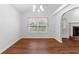 Dining room featuring hardwood floors, a window with blinds, and an adjacent kitchen at 9283 Whaleys Lake Ln, Jonesboro, GA 30238