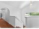 Bright entryway featuring white walls and trim, wood floors, and an open staircase to the upper level at 9283 Whaleys Lake Ln, Jonesboro, GA 30238