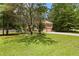 Well-maintained home with a large yard, showcasing a serene, tree-lined suburban setting on a sunny day at 9283 Whaleys Lake Ln, Jonesboro, GA 30238