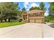 Charming two-story home with a spacious driveway and well-kept front lawn, nestled among mature trees at 9283 Whaleys Lake Ln, Jonesboro, GA 30238