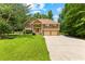 Attractive two-story home featuring a manicured lawn, mature trees, and an inviting front entrance at 9283 Whaleys Lake Ln, Jonesboro, GA 30238