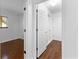 Hallway featuring hardwood floors, white trim, and access to a room at 9283 Whaleys Lake Ln, Jonesboro, GA 30238