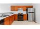 Kitchen featuring wooden cabinets, appliances, and a stainless steel refrigerator at 9283 Whaleys Lake Ln, Jonesboro, GA 30238