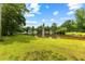 Expansive green lawn leading to a calm lake, perfect for relaxation and enjoying the outdoors at 9283 Whaleys Lake Ln, Jonesboro, GA 30238
