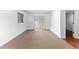 Spacious living room featuring sliding glass doors, neutral carpet, and white walls at 9283 Whaleys Lake Ln, Jonesboro, GA 30238