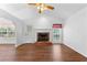 Bright living room featuring vaulted ceilings, a brick fireplace, and wood-look flooring at 9283 Whaleys Lake Ln, Jonesboro, GA 30238