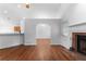 Open-concept living room featuring vaulted ceilings, a fireplace, and hardwood floors at 9283 Whaleys Lake Ln, Jonesboro, GA 30238