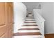 Elegant staircase leading to the upper level, showcasing natural light and clean design elements at 9283 Whaleys Lake Ln, Jonesboro, GA 30238