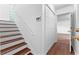Light stairwell features wood stairs, a closet and access to a living area at 9283 Whaleys Lake Ln, Jonesboro, GA 30238