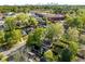 An aerial view of neighborhood homes, trees, and a retail area with the city skyline in the distance at 1450 Oglethorpe Sw Ave, Atlanta, GA 30310