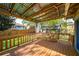 Back porch with a metal roof, lights and wooden deck overlooking the yard at 1450 Oglethorpe Sw Ave, Atlanta, GA 30310