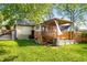 Backyard featuring a deck, small patio, green lawn and a detached garage at 1450 Oglethorpe Sw Ave, Atlanta, GA 30310