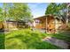 A backyard features a wooden deck with corrugated metal roof, a wooden fence and green grass at 1450 Oglethorpe Sw Ave, Atlanta, GA 30310