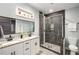 Bathroom featuring a double sink vanity, glass shower and a shelf of potted plants at 1450 Oglethorpe Sw Ave, Atlanta, GA 30310