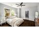 A bright and airy bedroom featuring a ceiling fan, ensuite bathroom, and hardwood floors at 1450 Oglethorpe Sw Ave, Atlanta, GA 30310