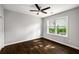 Bedroom featuring hardwood floors, a ceiling fan and a window with a view of greenery at 1450 Oglethorpe Sw Ave, Atlanta, GA 30310