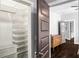 Walk-in closet with an organizer and view into the hallway and chest of drawers at 1450 Oglethorpe Sw Ave, Atlanta, GA 30310