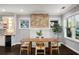 Bright dining room featuring a decorative brick fireplace, hardwood floors, and ample natural light at 1450 Oglethorpe Sw Ave, Atlanta, GA 30310