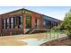 Exterior view of ASW Whiskey Exchange with bike racks, stairs, and large warehouse windows at 1450 Oglethorpe Sw Ave, Atlanta, GA 30310