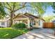 Charming bungalow featuring a well-manicured lawn, inviting front porch, and unique architectural details at 1450 Oglethorpe Sw Ave, Atlanta, GA 30310