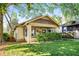 Charming bungalow featuring a well-manicured lawn, inviting front porch, and unique architectural details at 1450 Oglethorpe Sw Ave, Atlanta, GA 30310