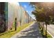 A long sidewalk bordered by a mural on a wall and a row of trees, enhancing the community's artistic appeal at 1450 Oglethorpe Sw Ave, Atlanta, GA 30310