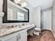 Well-lit bathroom with granite countertops, wood floors, and updated fixtures at 2311 October Nw Ct, Acworth, GA 30102