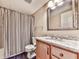 Cozy bathroom with granite countertop, wood vanity and large mirror over blue tile flooring at 2311 October Nw Ct, Acworth, GA 30102