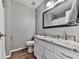 Clean, well lit bathroom with white vanity and granite countertop and a large mirror at 2311 October Nw Ct, Acworth, GA 30102