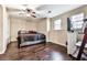 Bedroom with dark hardwood floors, fan and natural light from the windows at 2311 October Nw Ct, Acworth, GA 30102