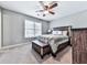 Neutral colored bedroom with a wood bed frame, ceiling fan and a chest at the end of the bed at 2311 October Nw Ct, Acworth, GA 30102