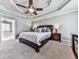 Comfortable primary bedroom suite with soft carpet and trey ceiling with fan, attached to primary bathroom at 2311 October Nw Ct, Acworth, GA 30102