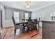 Traditional dining room featuring a wood table set on hardwood floors and a decorative light fixture at 2311 October Nw Ct, Acworth, GA 30102