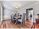 The dining room offers hardwood floors, wainscoting, and a decorative light fixture at 2311 October Nw Ct, Acworth, GA 30102