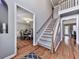 Inviting entryway features hardwood floors, a staircase with white railings, and views into adjacent rooms at 2311 October Nw Ct, Acworth, GA 30102