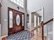 Elegant foyer with hardwood floors, a soaring ceiling, and decorative front door at 2311 October Nw Ct, Acworth, GA 30102