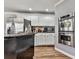 This is a beautifully designed kitchen with stainless steel appliances and dark ornate kitchen island at 2311 October Nw Ct, Acworth, GA 30102