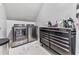Laundry room with stainless steel washer and dryer, and built in storage cabinet at 2311 October Nw Ct, Acworth, GA 30102