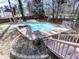 Refreshing backyard pool with a sunbathing area and lush landscaping, creating a private oasis for relaxation at 2311 October Nw Ct, Acworth, GA 30102