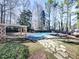 Inviting pool area with stone pathway and wood structure at 2311 October Nw Ct, Acworth, GA 30102