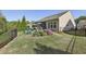 Wide angle of landscaped backyard with iron fence, lawn, patio set, and mature plantings at 5035 Castlegate Ct, Cumming, GA 30040